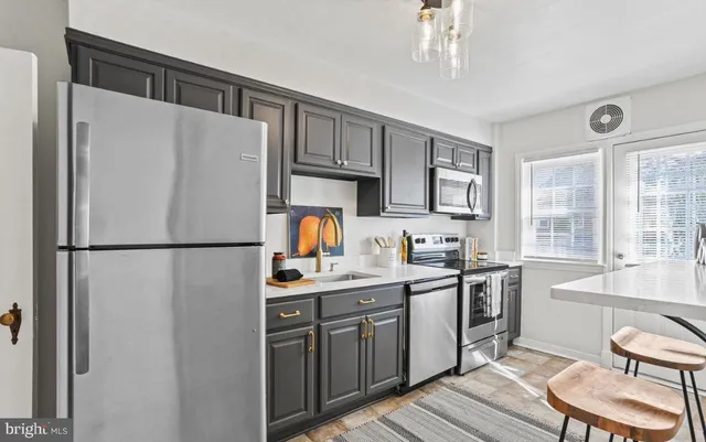 a kitchen with stainless steel appliances a refrigerator sink and cabinets