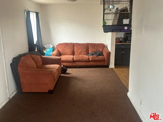 a living room with furniture and a walk in closet