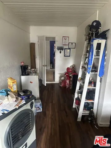 a view of a workspace with furniture and wooden floor