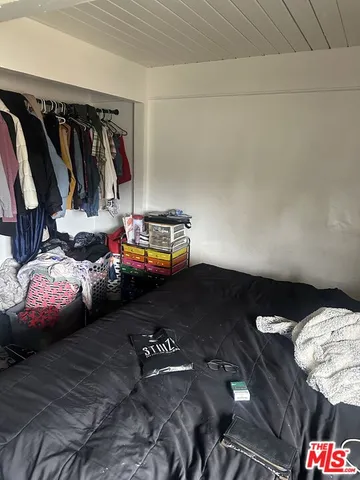 a bedroom with bed and a closet