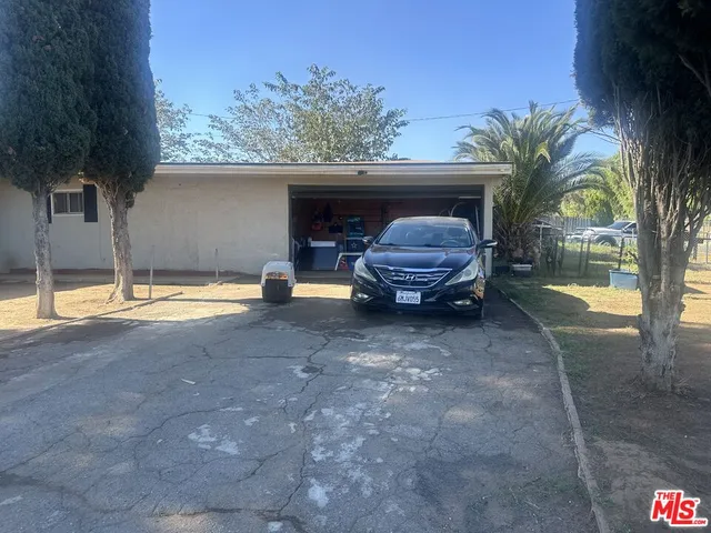 a view of backyard with swimming pool and outdoor seating