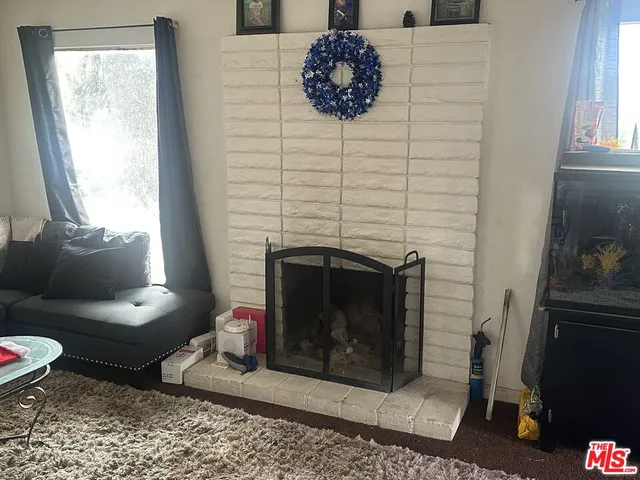 a living room with a fireplace and a table