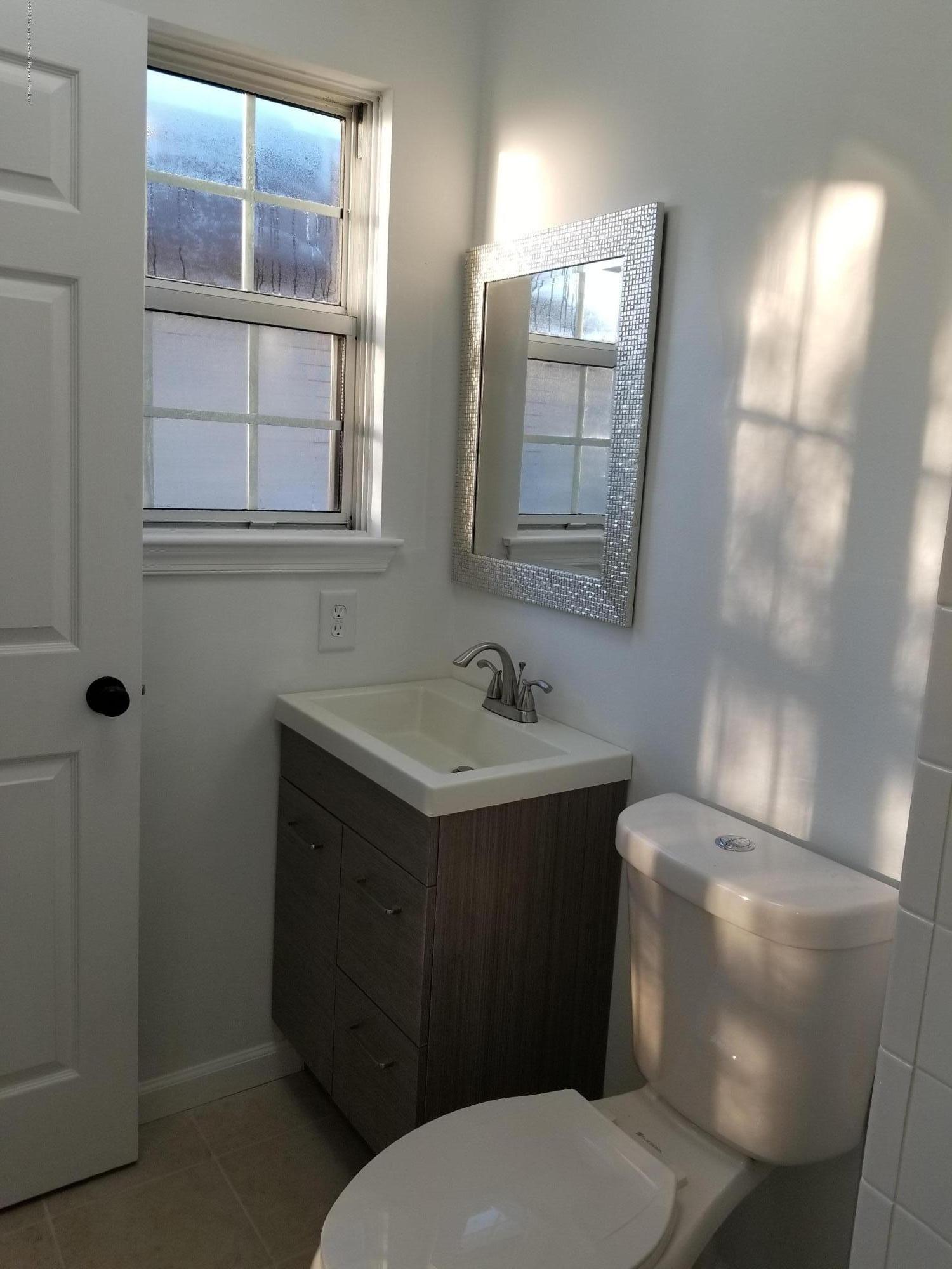 33 Ivy Ridge Close, Unit 1000 Freehold, NJ 07728 - Photo 23 of 31 a bathroom with a toilet sink and mirror
