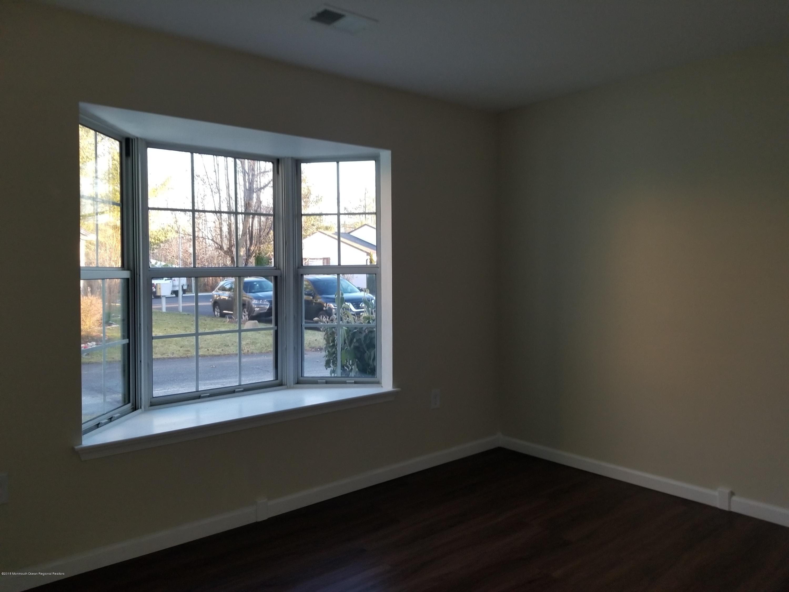 33 Ivy Ridge Close, Unit 1000 Freehold, NJ 07728 - Photo 27 of 31 a view of an empty room with a window
