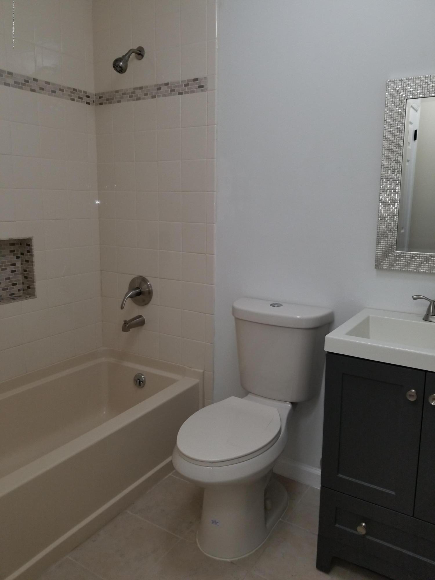 33 Ivy Ridge Close, Unit 1000 Freehold, NJ 07728 - Photo 29 of 31 a white toilet sitting next to a bath tub