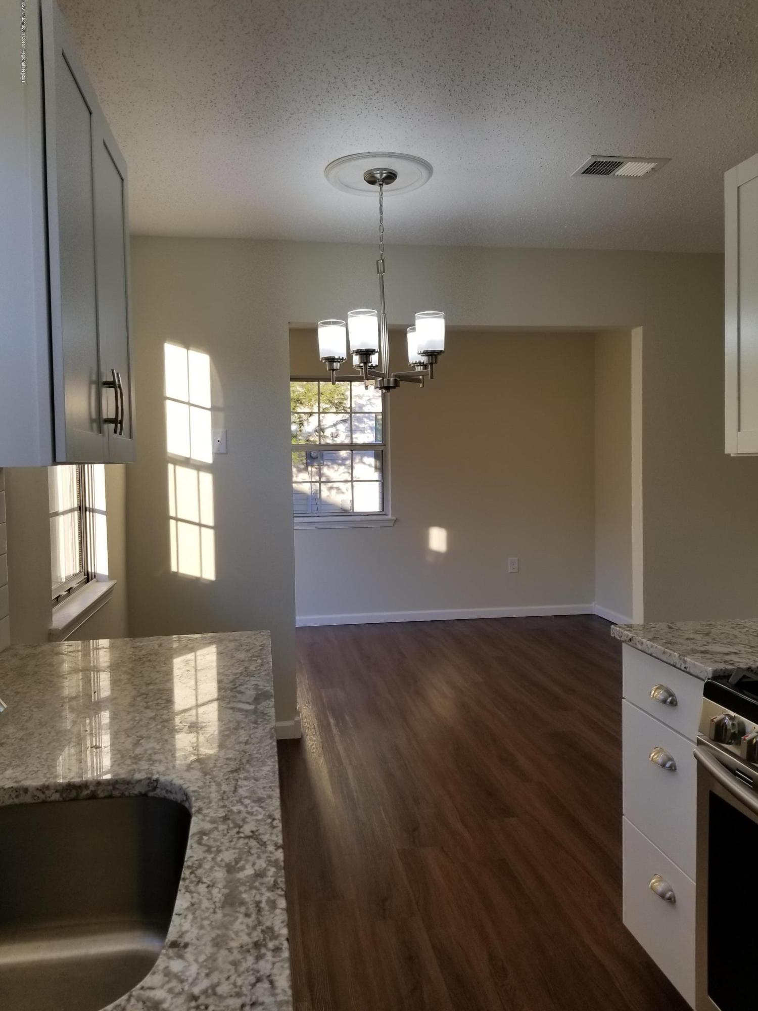 33 Ivy Ridge Close, Unit 1000 Freehold, NJ 07728 - Photo 4 of 31 a view of a kitchen with a sink dishwasher and wooden floor