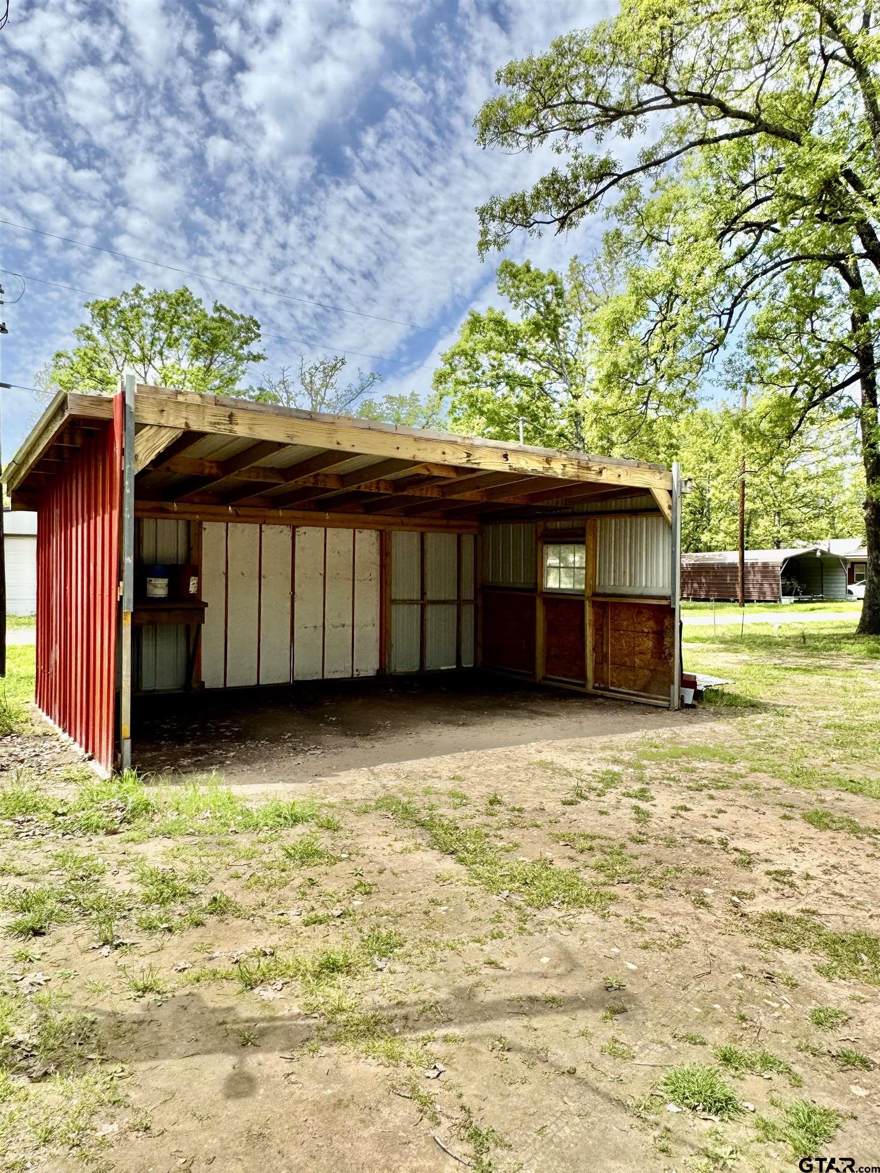 107 Private Road 7713 Emory, TX 75440 - Photo 11 of 22 a view of a house with a yard and garage