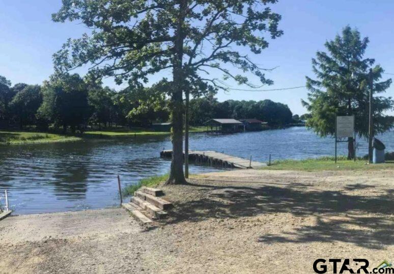107 Private Road 7713 Emory, TX 75440 - Photo 20 of 22 a view of a lake with a barn in the background