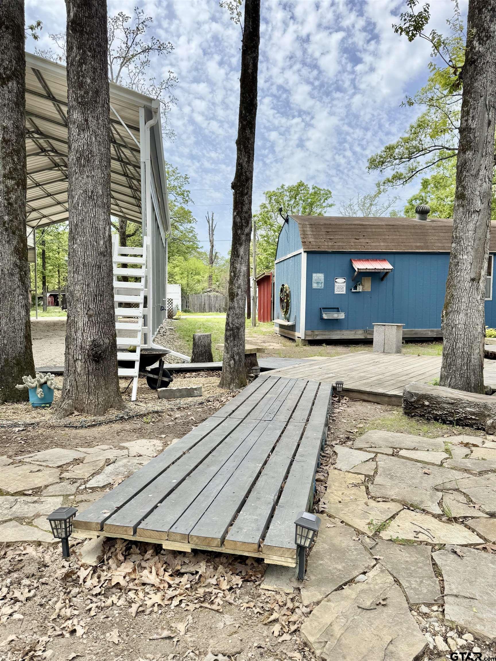 107 Private Road 7713 Emory, TX 75440 - Photo 3 of 22 a view of a backyard with a sitting area