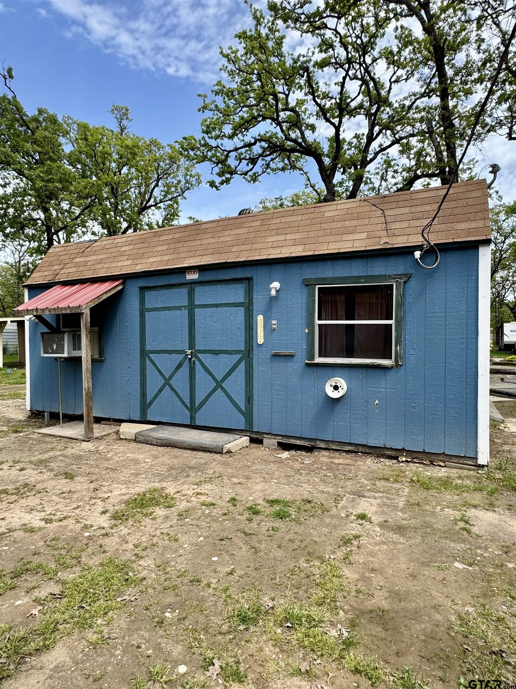 107 Private Road 7713 Emory, TX 75440 - Photo 5 of 22 a house with trees in the background