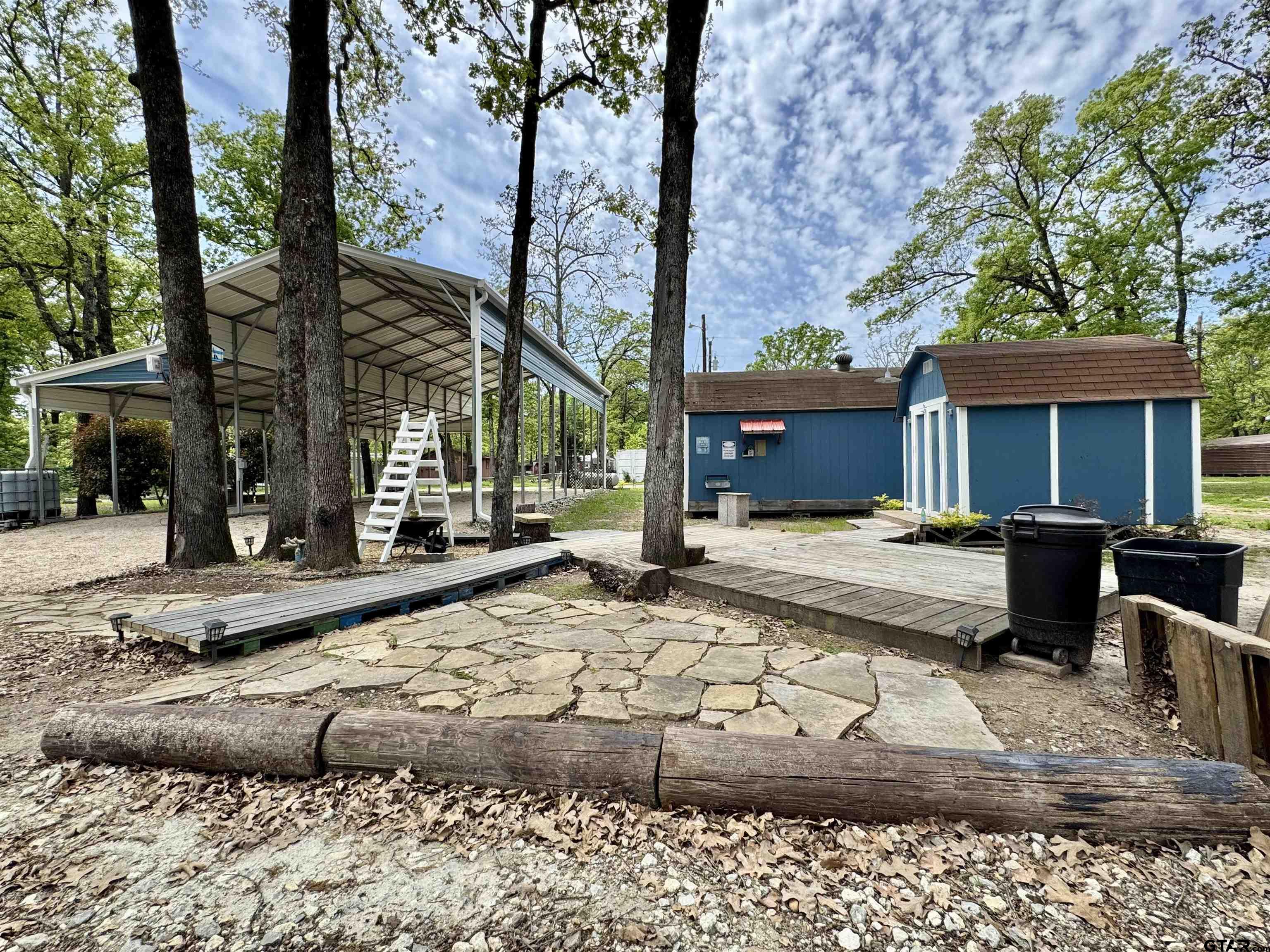 107 Private Road 7713 Emory, TX 75440 - Photo 7 of 22 a view of a house with a patio