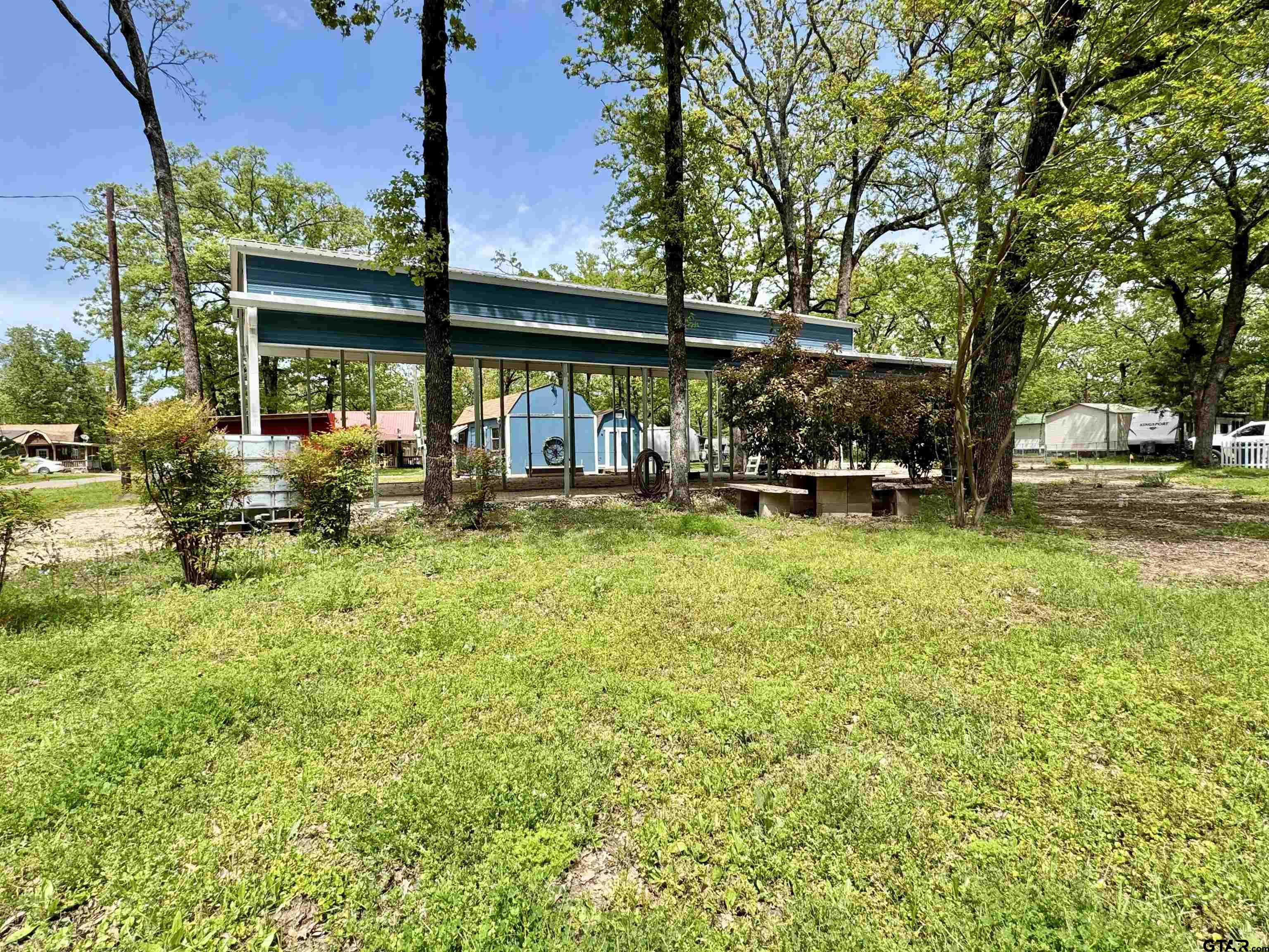 107 Private Road 7713 Emory, TX 75440 - Photo 9 of 22 a view of a swimming pool and trees in the background