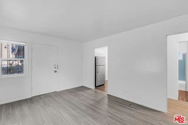 a view of a kitchen with a sink and a refrigerator