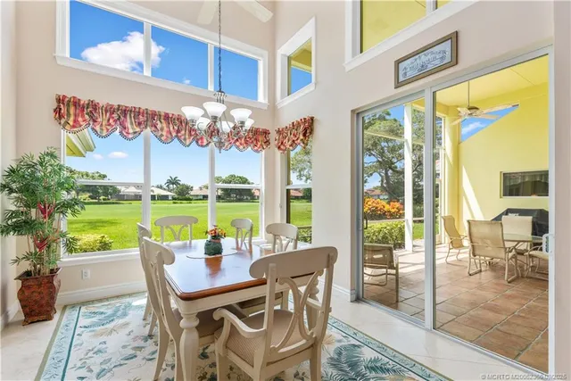 a view of a chairs and table in patio with a swimming pool