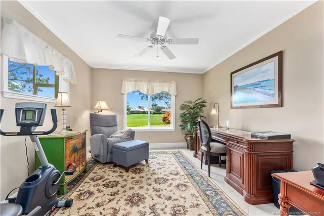 a living room with furniture a window and a flat screen tv