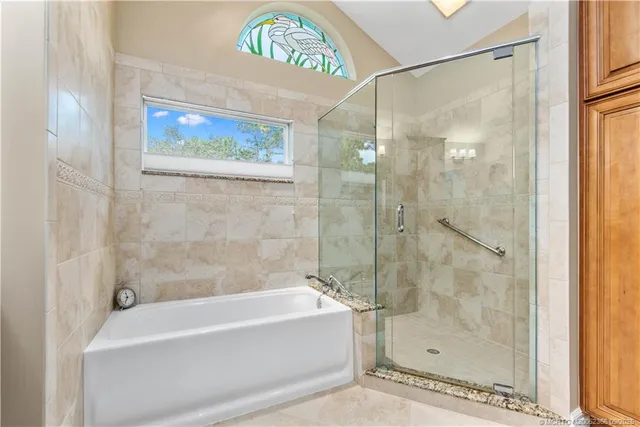 a bathroom with a bathtub and a shower