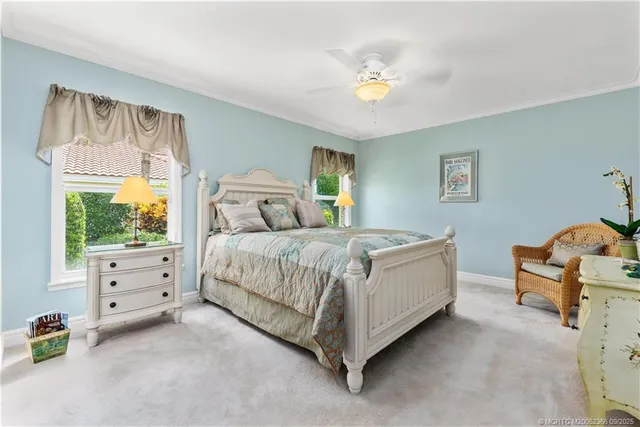 a spacious bedroom with a bed and a chandelier