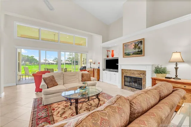 a living room with furniture fireplace and a large window