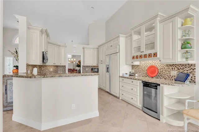 a kitchen with granite countertop cabinets stainless steel appliances and a sink