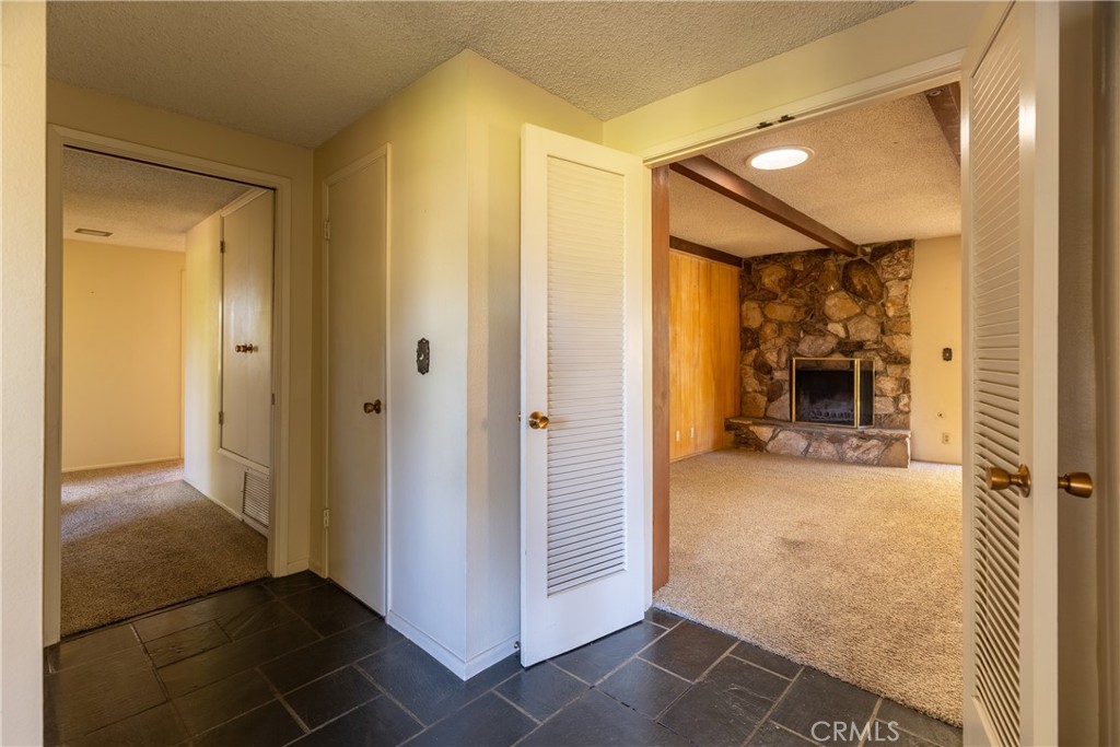 12952 Club Drive Redlands, CA 92373 - Photo 17 of 35 a view of a hallway with wooden shelves