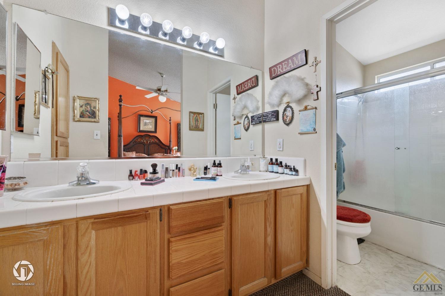 Undisclosed Address Bakersfield, CA 93312 - Photo 15 of 33 a bathroom with a double vanity sink mirror and toilet