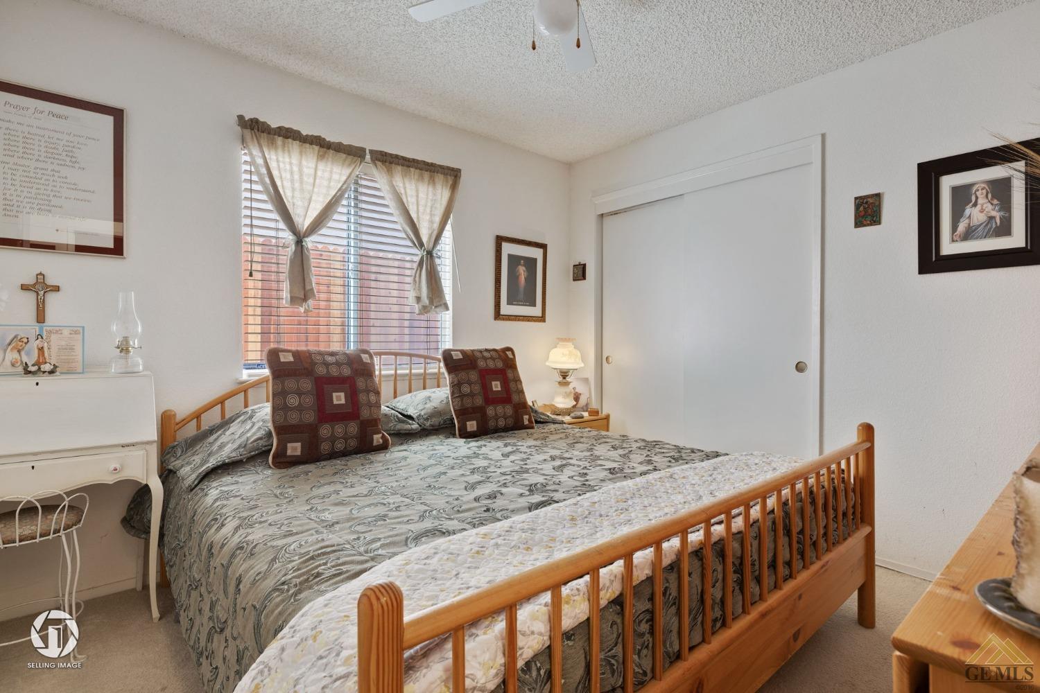 Undisclosed Address Bakersfield, CA 93312 - Photo 17 of 33 a bedroom with a bed and wooden floor