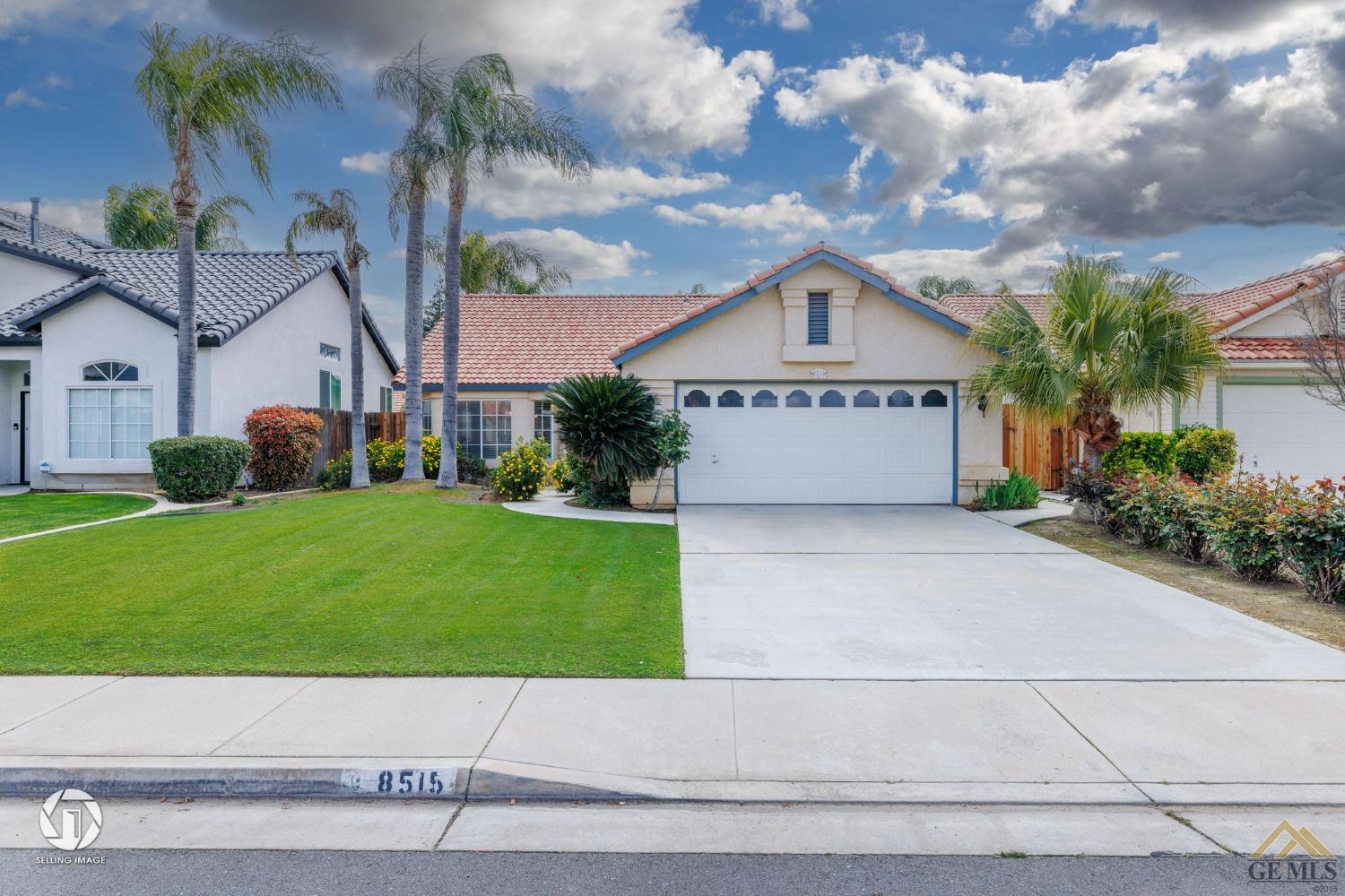 Undisclosed Address Bakersfield, CA 93312 - Photo 2 of 33 a front view of a house with a yard and garage
