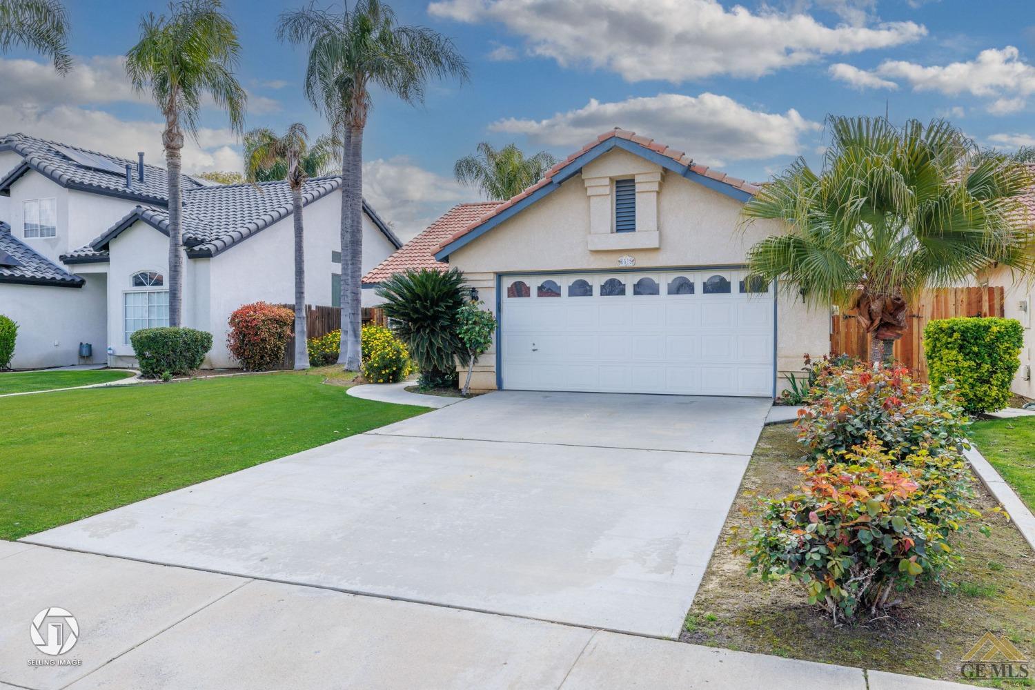 Undisclosed Address Bakersfield, CA 93312 - Photo 27 of 33 a view of front of house with a yard and palm trees