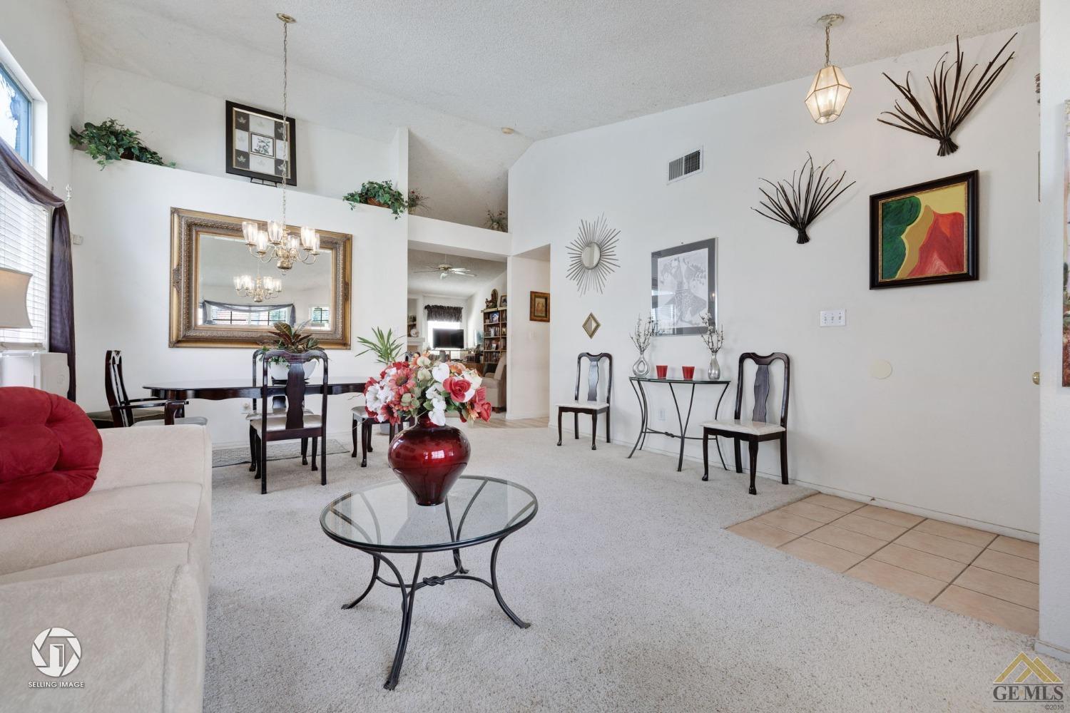Undisclosed Address Bakersfield, CA 93312 - Photo 31 of 33 a living room with furniture a chandelier and a flat screen tv