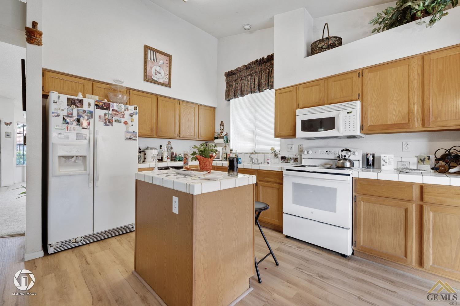 Undisclosed Address Bakersfield, CA 93312 - Photo 9 of 33 a kitchen with stainless steel appliances granite countertop a refrigerator sink and microwave