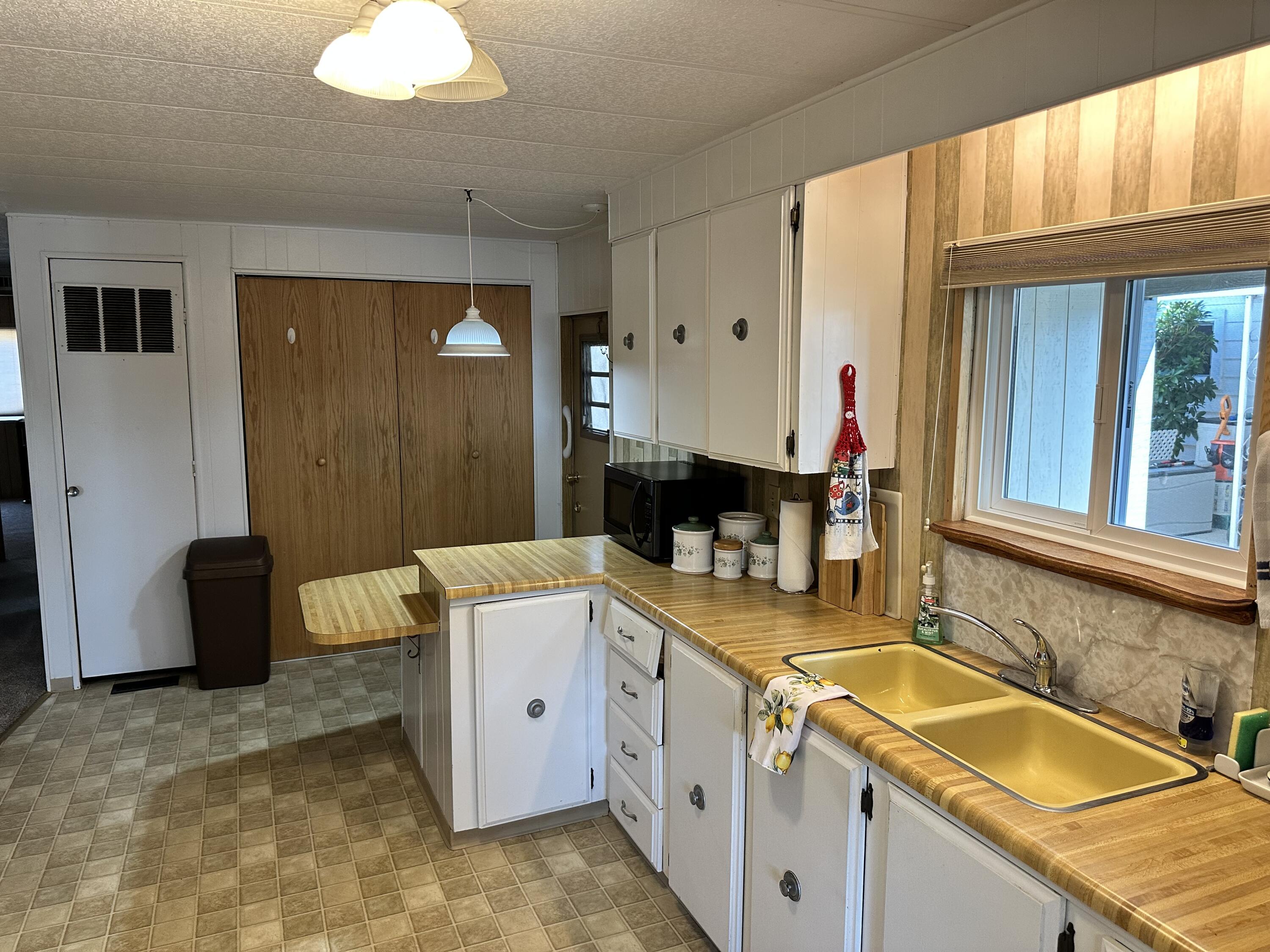 2252 West Table Rock Road, Unit 207 Medford, OR 97501 - Photo 12 of 39 Kitchen laundry behind wooden doors