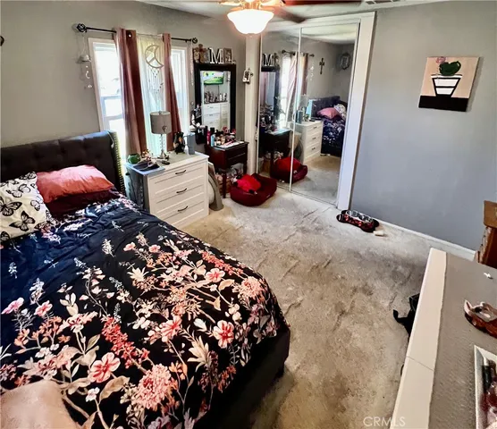 a bedroom with bed and window