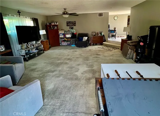 a view of a livingroom with furniture and a flat screen tv