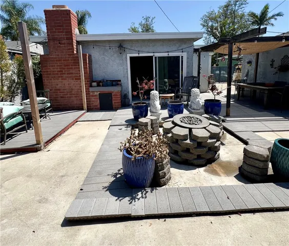 a view of a patio with dining table and chairs