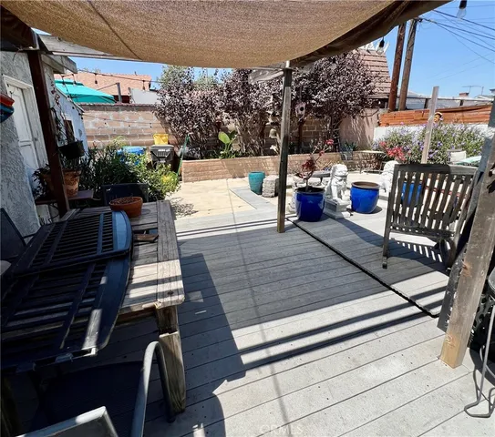 a view of a patio with couches table and chairs with potted plants