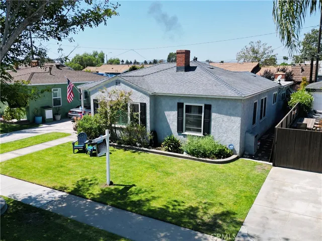 a house view with swimming pool and garden space