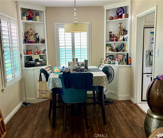 a dining room with furniture window and wooden floor