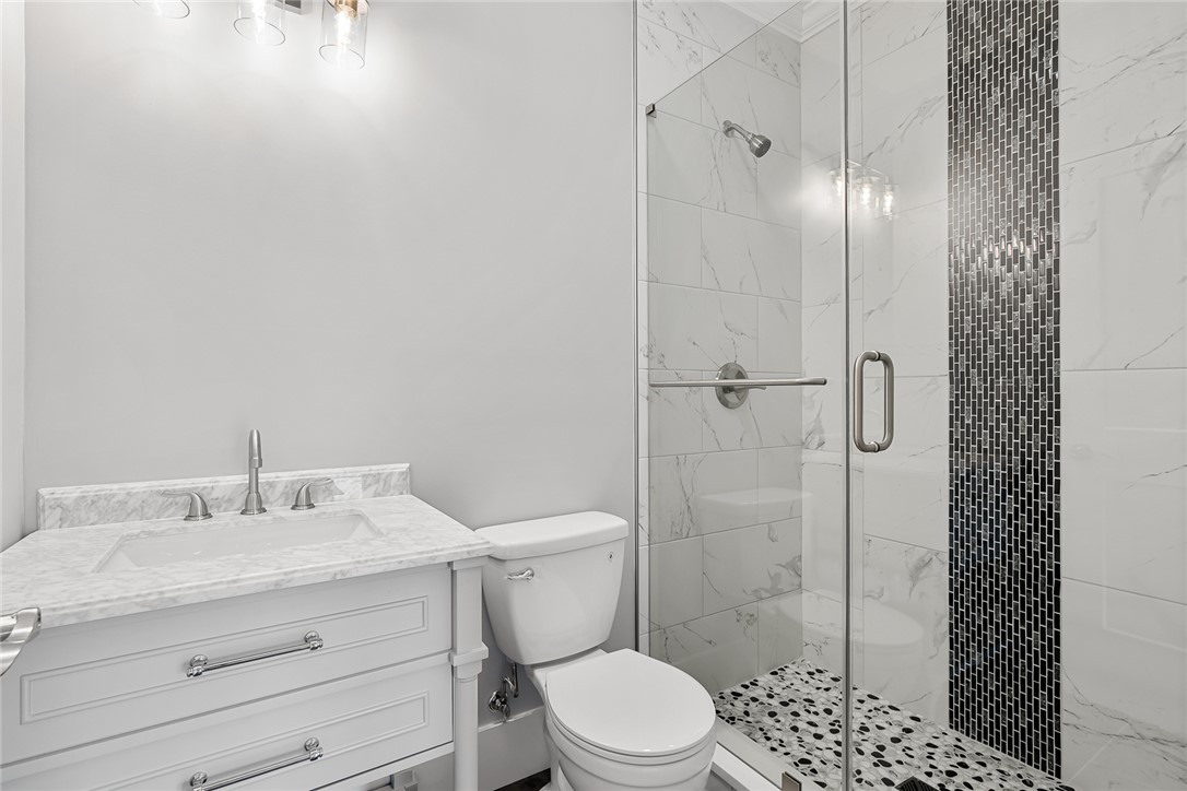303 Regency Circle Anderson, SC 29625 - Photo 28 of 50 This sleek bathroom features a modern vanity and a spacious shower with stylish tile accents.