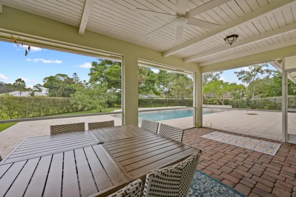 a view of house with swimming pool outdoor seating
