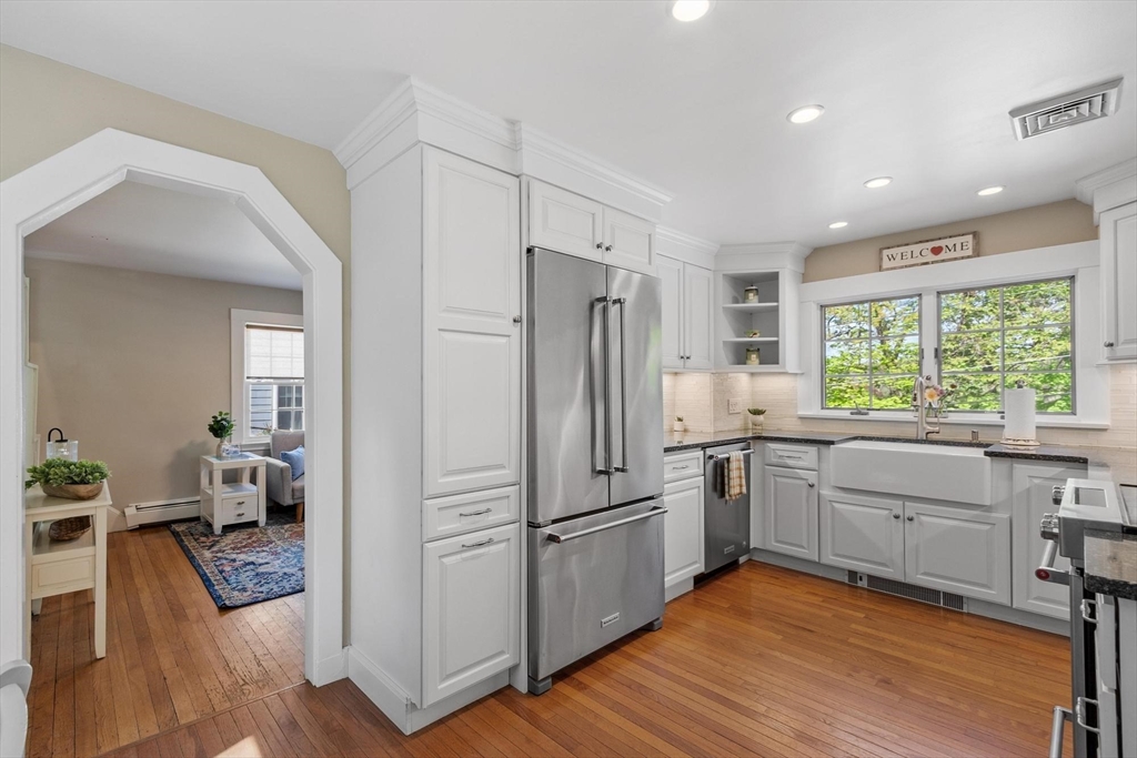25 Naples Road Melrose, MA 02176 - Photo 12 of 36 a kitchen with a refrigerator a sink and dishwasher with wooden floor