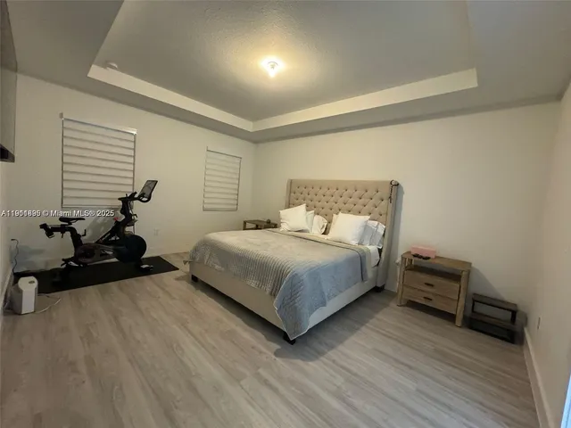 a bedroom with a bed and a tv