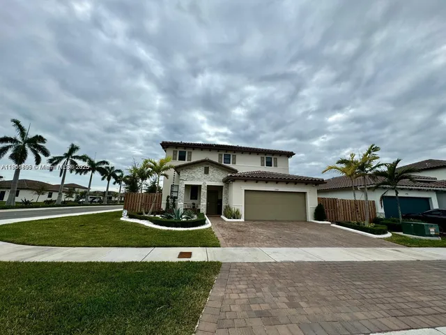 a front view of a house with a yard and garage