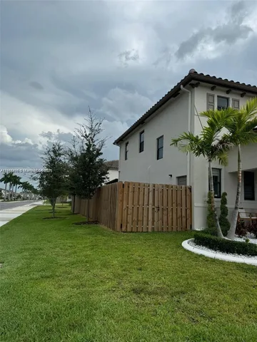 a view of a house with a yard and plants