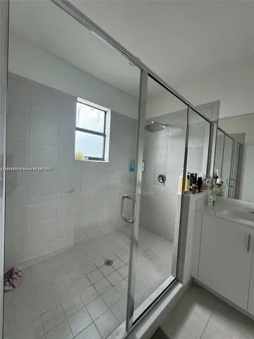 a bathroom with a glass shower door