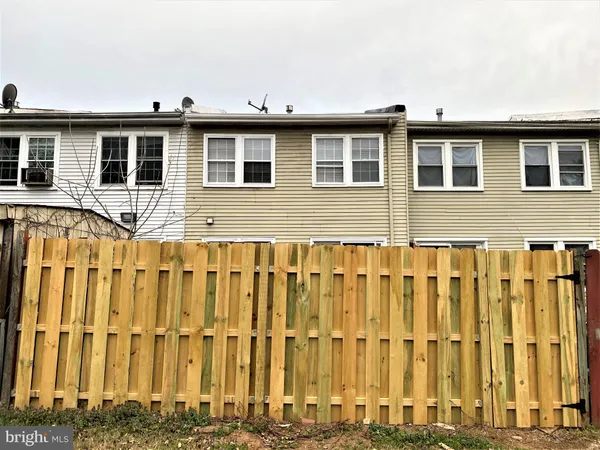 a front view of a house with a wooden fence