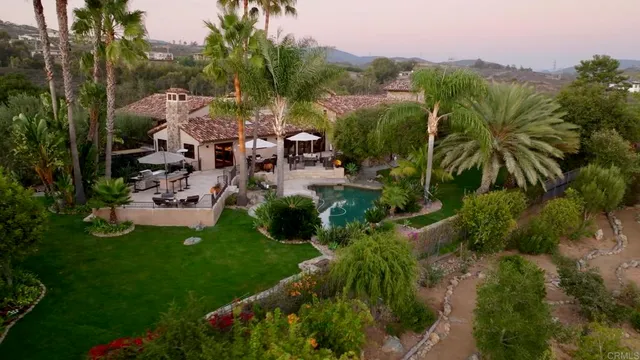 a view of a backyard with sitting area