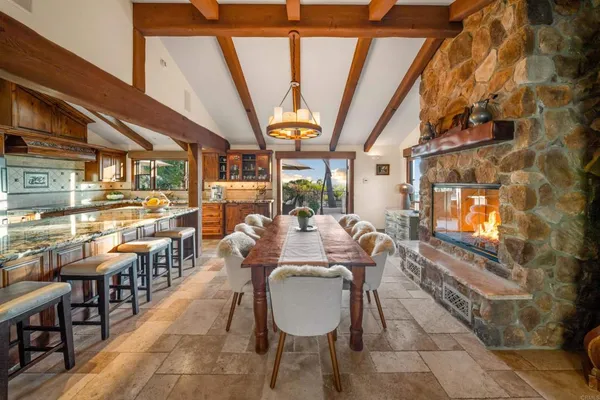 a kitchen with stainless steel appliances granite countertop sink stove and table