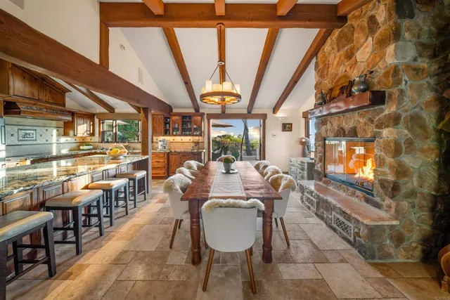 a kitchen with stainless steel appliances granite countertop sink stove and table
