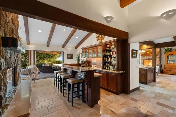 a living room with patio furniture and a fireplace