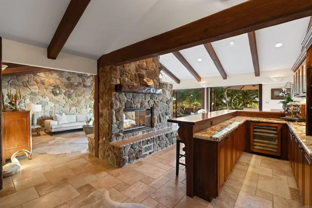 a living room with furniture and a floor to ceiling window